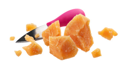 Parmesan cheese cut pieces and kitchen knife isolated on white background