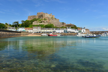 Jersey, U.K. July 13th 2019, the 12th century landmark and harbour of Gorey, Mont Orguiel Castle in the Summer at high tide.