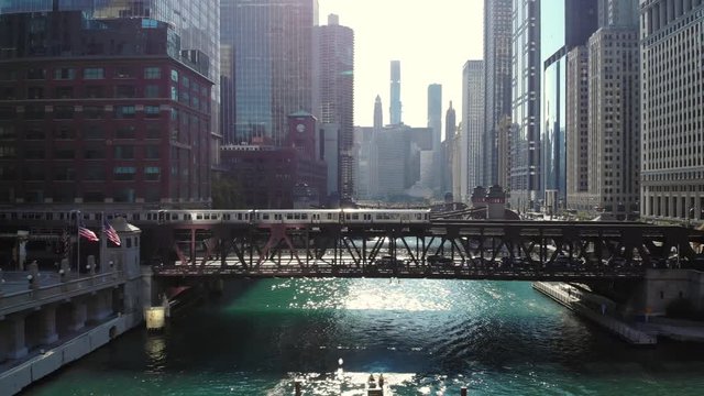 Chicago downtown skyline aerial buildings drone train moving over river bridge