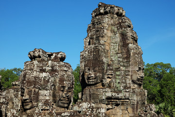 A huge human face built of stone blocks. Huge human faces on the towers of the Bayon temple in...