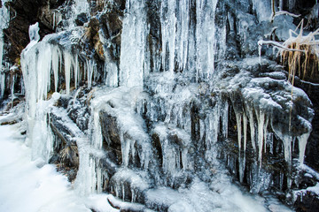 Icicles on the rocks in cold winter