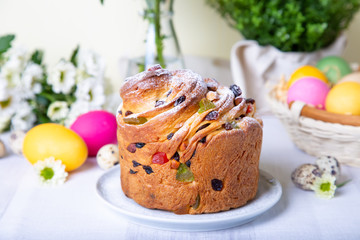 Craffin (Cruffin) with raisins and candied fruits. Easter Bread Kulich and painted eggs. Easter Holiday. Close-up.