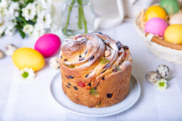 Craffin (Cruffin) with raisins and candied fruits. Easter Bread Kulich and painted eggs. Easter Holiday. Close-up.