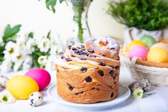 Craffin (Cruffin) with raisins and candied fruits. Easter Bread Kulich and painted eggs. Easter Holiday. Close-up.