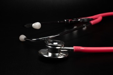 Stethoscopes are among the most important tools a nurse or doctor on black background