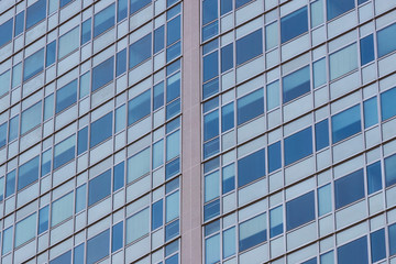 Fototapeta na wymiar Background of the windows and balconies of the multi-storey building.