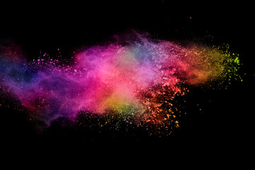 abstract colored dust explosion on a black background.abstract powder splatted background,Freeze motion of color powder exploding/throwing color powder, multicolored glitter texture.