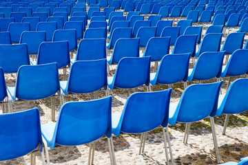 Rows of plastic chairs for spectators in the stands 
