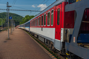 Obraz premium Night train with sleeping coaches and car motorcycle coaches Kysak station