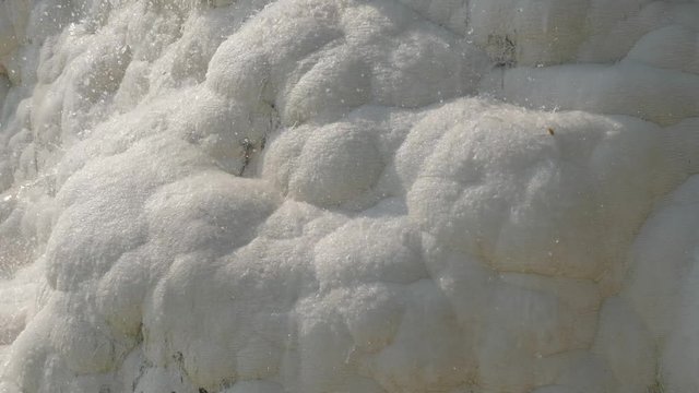 clear water flows down from the white mountain of limestone marble mountain