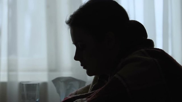 Silhouette girl slowly falling asleep, feels achy and tired, first flu symptoms