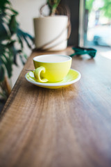Cappuccino in a yellow cup.