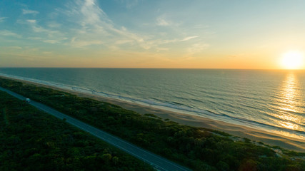 Fototapeta na wymiar Sunrise over the beach and road