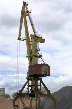 Large industrial construction crane at a construction site of houses