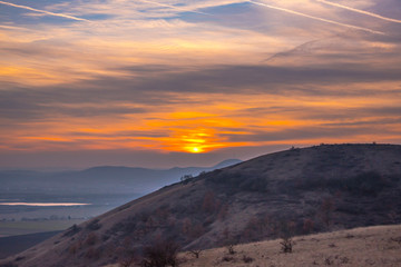 Fototapeta na wymiar Springtime landscape at the sunset on the hill