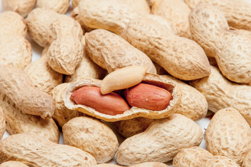 Large peeled peanuts close-up of beans in the shell. Unpeeled peanuts in the shell. Peanuts, for background or texture. Growing organic protein. Macro
