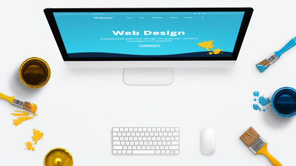 Concept of a modern web design studio with color brushes and color boxes on a clean desk. Modern...