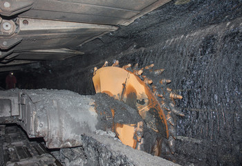 Coal mine excavator and miner under the ground. Industry