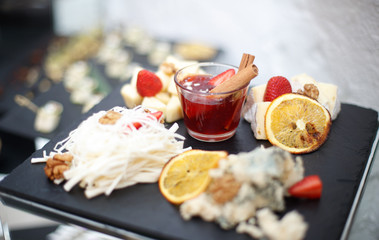 Beautifully decorated catering banquet table with different food snacks and appetizers.