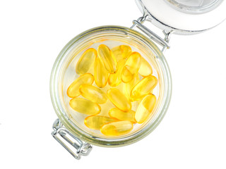 Cod liver oil omega 3 gel capsules in glass jar isolated on white background