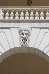 Masks of satyrs in relief of the building