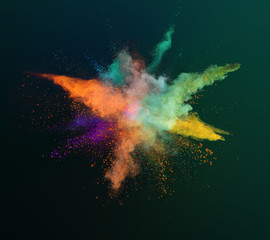 Colored powder explosion on black background. Freeze motion.