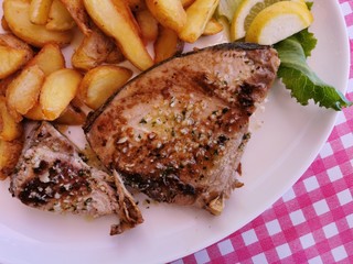Fried Tuna Steaks on  White Plate  on Table