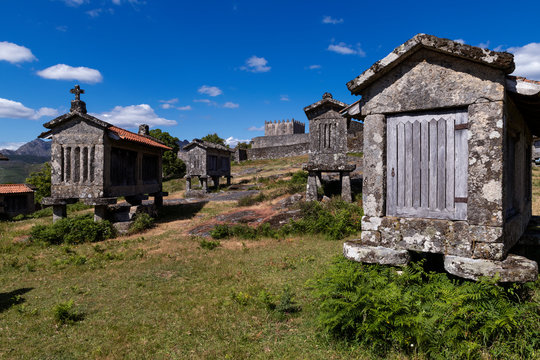 View of the granaries (espigueiros) and medieval castle in the historic village of Lindoso, Portugal.