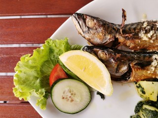 cooked mackerel fish meal with spinach on the top