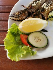 cooked mackerel fish meal with spinach on the top