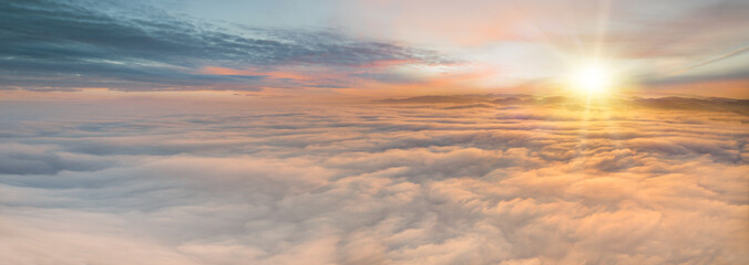 Naklejka na ściany i meble Sunset sky with beautiful clouds from the airplane window