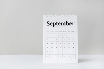 Flip calendar on table against light background