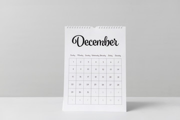 Flip calendar on table against light background