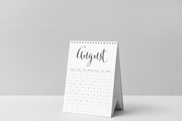 Flip calendar on table against light background