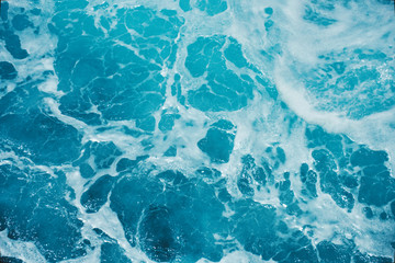 Abstract blue sea water with white foam for background
