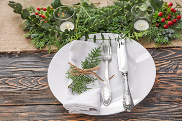 Beautiful table setting with floral decor on wooden background