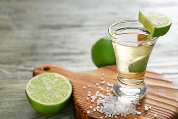 Shot of tequila on wooden background