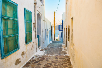Street view of Plaka village with paved alleys and traditional cycladic architecture in Milos island in Cyclades, Greece