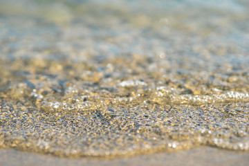 close up of a wave rolling onto the beach