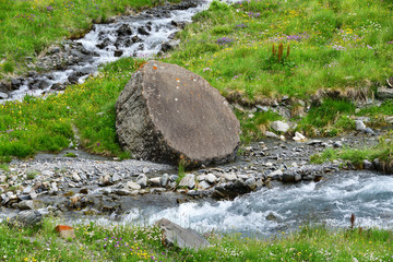 Naklejka na ściany i meble Large round stone in the upper reaches of the river Zrug. Russia, North Ossetia - Alania
