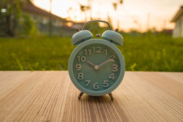 lite blue  analog clock over blurry background