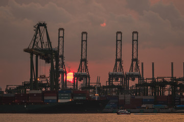 Fototapeta na wymiar Sunset against a port