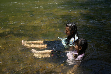 Family Asian Children Play Water in the river