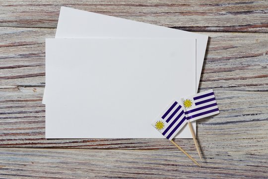 happy Uruguay independence day. August 25. the concept of freedom, independence and patriotism. mini flags with sheets of white paper on wooden background. horizontal