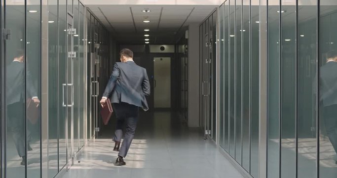 Funny businessman making dance break in office hall, celebrating his victory. Caucasian manager cheering about his achievement - way to success concept 4k