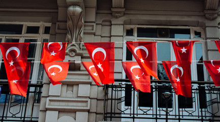 Turkish national flags with white star and moon in sky