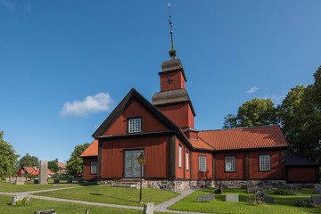 Fototapeta na wymiar Church in the landscape at Roslags Kulla in the district Roslagen in Stockholm northen archipelago a sunny summer day. 
