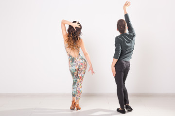 Social dance, kizomba, tango, salsa, people concept - beautiful couple dancing bachata on white...