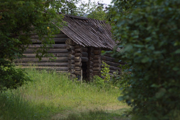 Fototapeta na wymiar old abandoned wooden houses in Russian village view in summer
