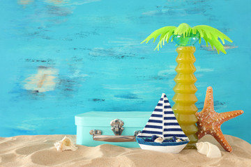 Fototapeta na wymiar nautical, vacation and travel image with sea life style objects in the beach sand
